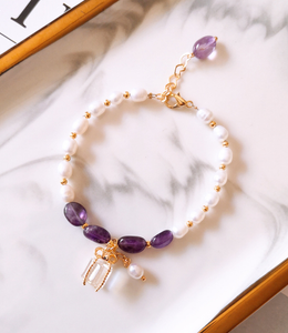 Bracelet with purple stones and pearls in gold